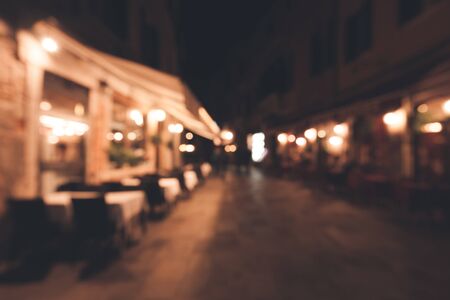 A crowd of people at the old town city night street defocused blurred abstract background Stock fotó