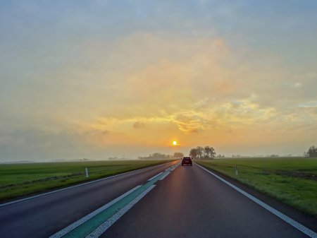 Driving at sunset in the countryside from friesland in the netherlands