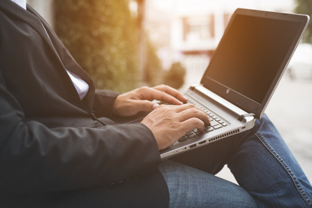 Working on laptop close up of hands of business man Stock Photo