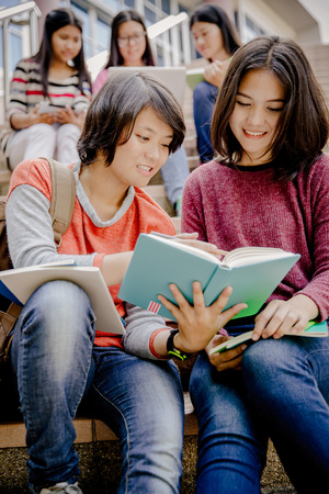 Group of happy teen high school students outdoors