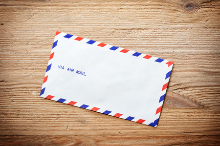 Air mail envelope on the wood table