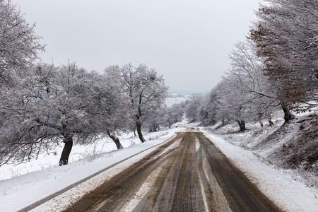 Photo of a snowy road in a winter landscape