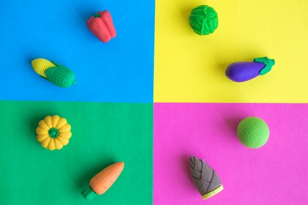 Different rubber vegetables on colorful background minimal creative concept