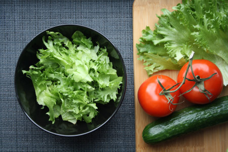 Fresh vegetables frieze tomatoes and cucumber prepared for slicing salad on a wooden background Stock Photo