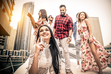 Group of friends making party on a yacht in dubai happy people having a fancy party on a luxury boat Stock Photo