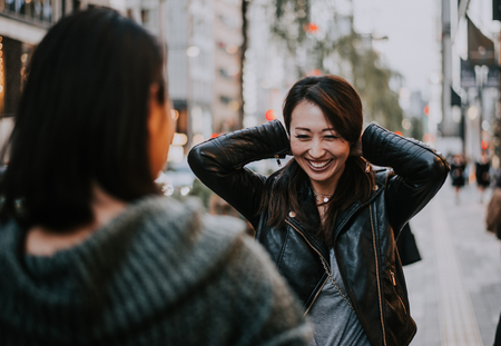 Two japanese women around in tokyo during daytime making shopping and having fun Stock Photo