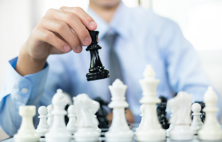 Hand of businessmen moving chess in competition shows leadership followers and business success strategies Stock Photo