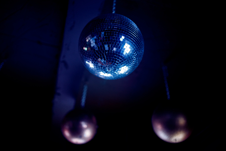 Dark background night party disco ball fixed to the ceiling Stock Photo