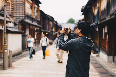 Asian male tourist taking photo at higashi chaya district kanazawa japan