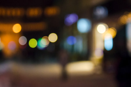 City street on winter holidays at night blurred urban background with festive illumination bokeh effect