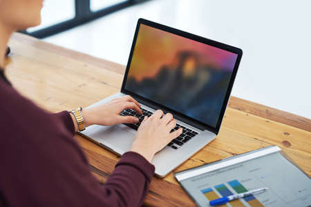 Great data management makes great business an unidentifiable woman using her laptop in the office