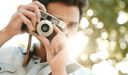 Keep calm and snap on a handsome young tourist holding his camera