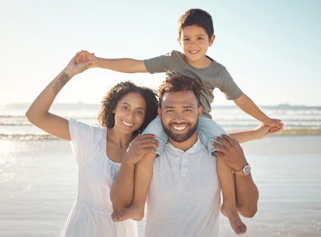 Happy family portrait and beach holiday with parents bonding with their son playful ocean fun love travel and family time with young man and woman enjoying a sea trip with their smiling son Foto de archivo