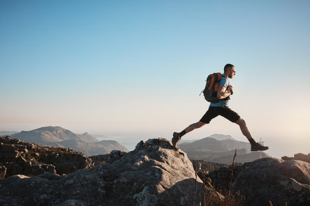 Hiking challenges you to push past your limits a mature man hiking up a mountain Stock Photo