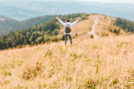 bergen reizen concept herfst seizoen geel gras wazig persoon op achtergrond