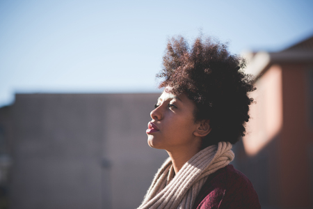 Beautiful black curly hair african woman in town