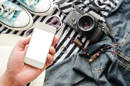 Close up of traveler hands with blank smartphone screen and map concept planning travel Stock Photo