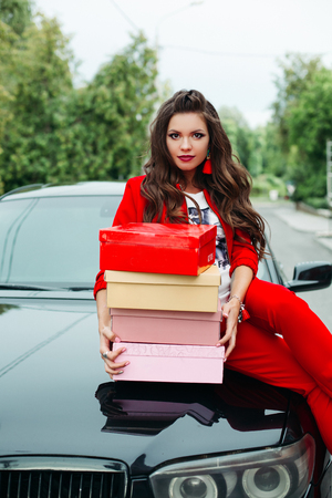 Stunning lady with stack of shoe boxes