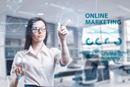 The concept of business technology the internet and the network a young entrepreneur working on a virtual screen of the future and sees the inscription online marketing