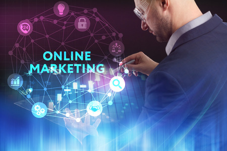 The concept of business technology the internet and the network a young entrepreneur working on a virtual screen of the future and sees the inscription online marketing Stock Photo