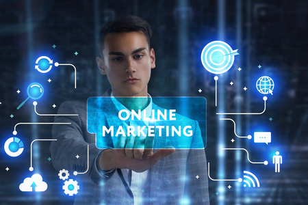 The concept of business technology the internet and the network a young entrepreneur working on a virtual screen of the future and sees the inscription online marketing