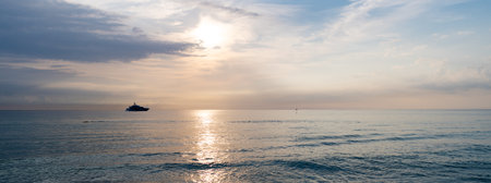 Panorama view of sunset sky in summer vacation skyscape with ship on horizon