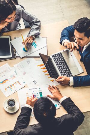 Business people group meeting shot from top view in office profession businesswomen businessmen and office workers working in team conference with project planning document on meeting table Stock Photo