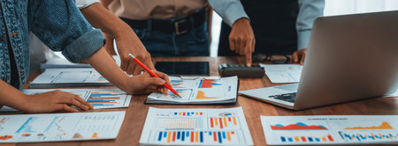 Analyst team utilizing bi fintech to analyze and pointing at financial dashboard paper office businesspeople examining report paper on table for business insight panorama shot scrutinize Stock Photo