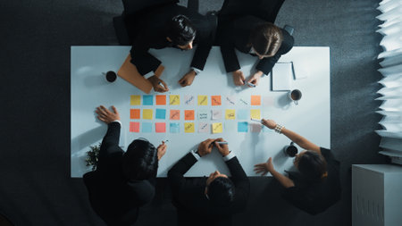 Top down aerial view of manager discuss and choose marketing idea from sticky notes group of business team talking and brainstorming strategy while making decision and choose plan directorate Stock Photo