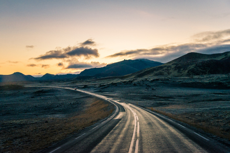 Iceland road on the horizon empty straight road line with twilight sky