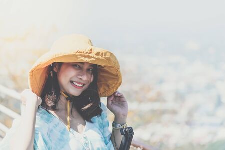 Asian pretty cute woman with hat relax at seaside city landscape viewpoint on mountain with happy and freedom emotion in concept travel vacation leisure in life Stock Photo