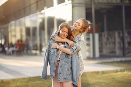 Elegant and stylish girls in a summer park