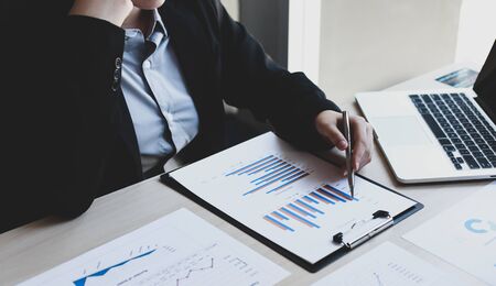 Financial businessmen analyze the graph of the company s performance to create profits and growth market research reports and income statistics financial and accounting concept Stock Photo