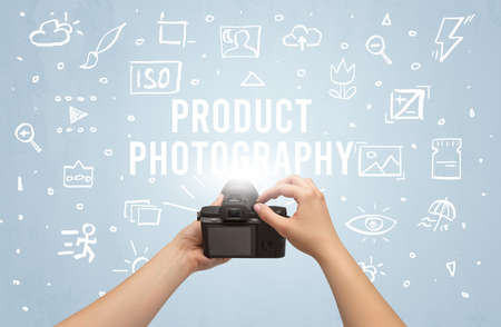 Hand taking picture with digital camera and product photography inscription camera settings concept