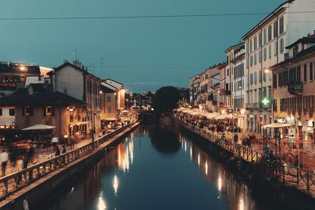 Vita notturna del canale Naviglio Grande con ristorante e bar a Milano, Italia.
