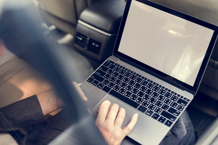 Buusiness people working usong laptop car inside Stock Photo