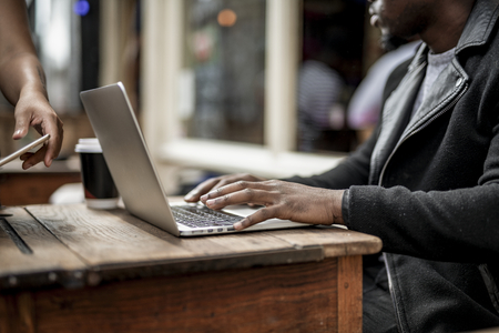 Businessman working remotely from a cafe Stock Photo