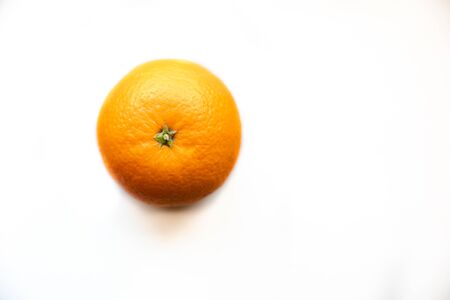 One organic raw orange on white isolated background