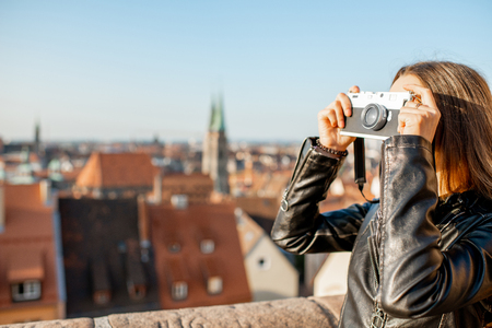 Young woman tourist enjoying beautiful aerial view on the old town of nurnberg city germany