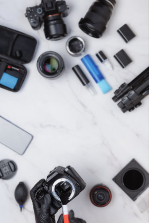 White marble desk top view of professional cameras cleaning station copy space ion the middle for advertisement