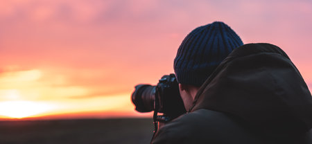 The photographer on the sunset shooting sunset landscape travel nature photography