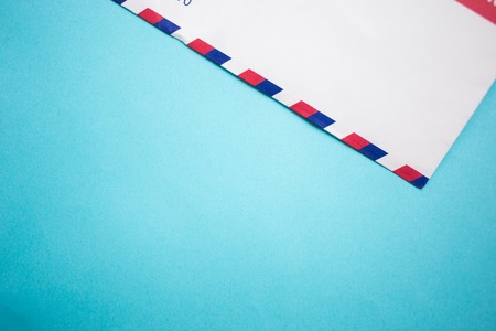Air mail envelope letter on blue background copy space