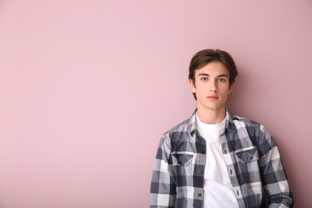 Handsome young man on color background Stock Photo