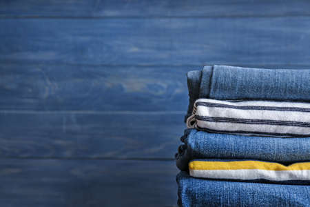 Stack of clothes on wooden background Stock Photo