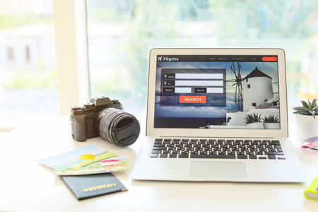 Open page of online booking service on screen of laptop on table