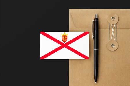 Jersey flag on craft envelope letter and black pen background national invitation concept invitation for education theme
