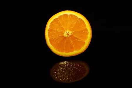 Orange slice isolated on black with reflection Stock Photo