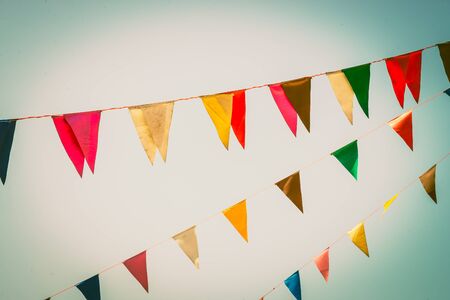 Colorful flag on blue sky vintage effect filter Stock Photo