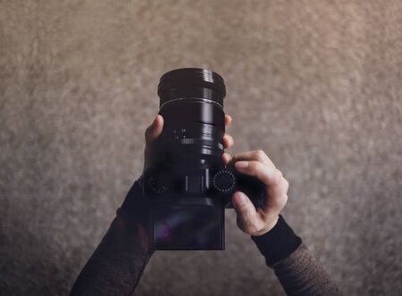 Young photographer woman using camera to taking photo dark tone pov or top view in low angle selective focus on lcd screen Stock Photo