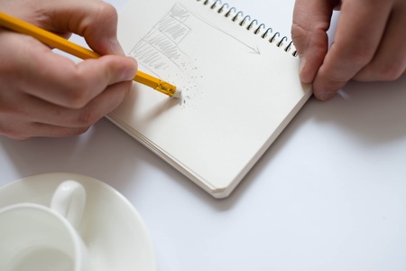 Businessman using a tablet pc and write something